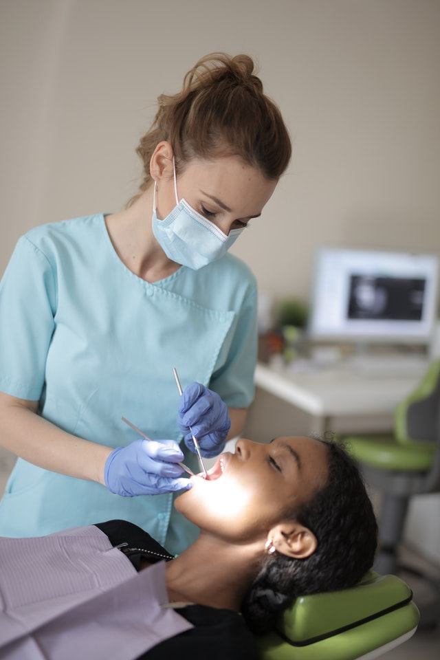 Dentist examining a patient during a dental check-up